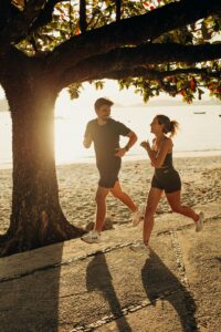 A person jogging along the sandy shoreline of Myrtle Beach during sunrise.