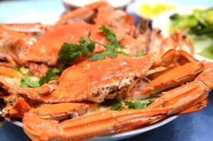 Attendees savoring fresh crab at the World Famous Blue Crab Festival in Little River.