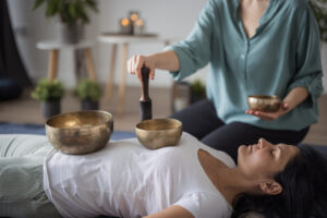 Participants experiencing sound healing and meditation with singing bowls in Myrtle Beach.