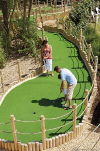 A family enjoying a round of mini golf at one of Myrtle Beach’s adventure parks.